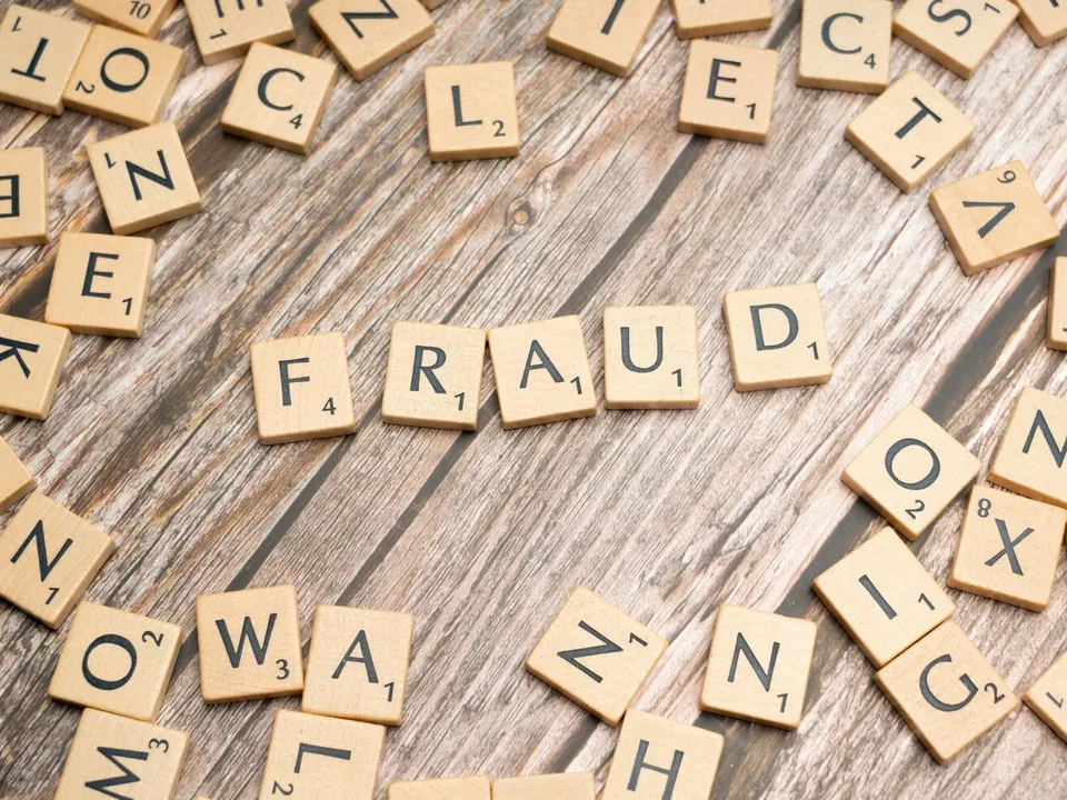 scrabble tiles spelling out the word fraud