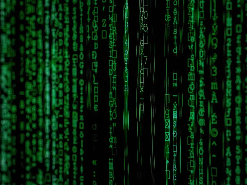 matrix movie still with green letters in many vertical lines across a black screen