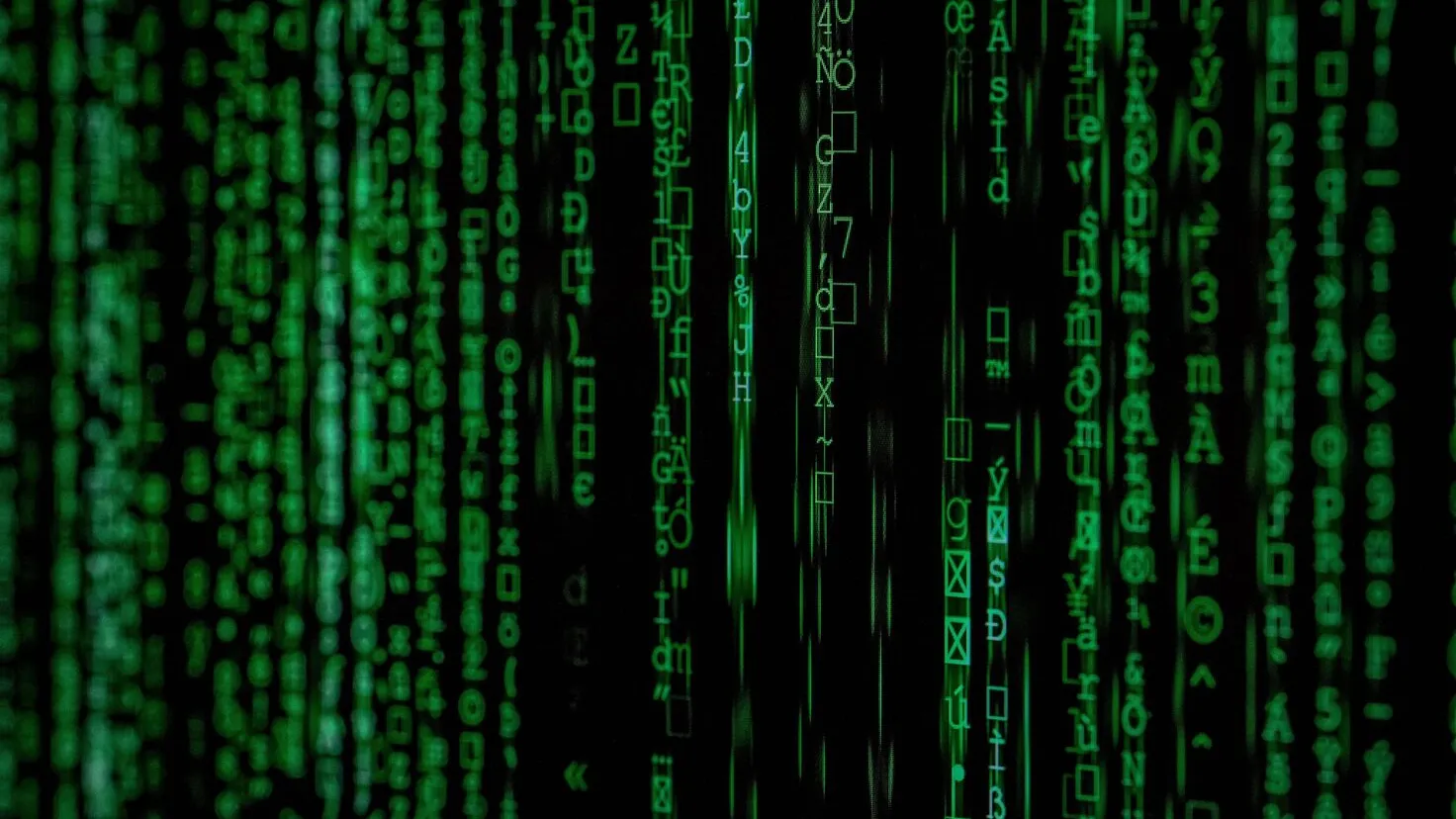 matrix movie still with green letters in many vertical lines across a black screen