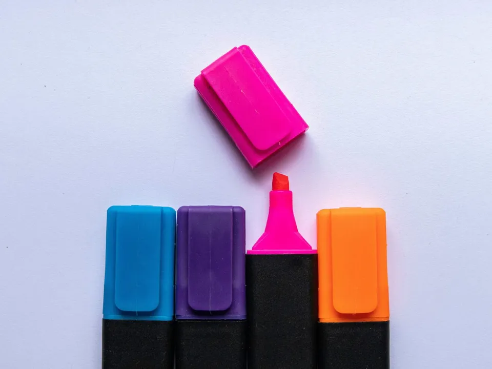 pink blue orange highlighters lined up