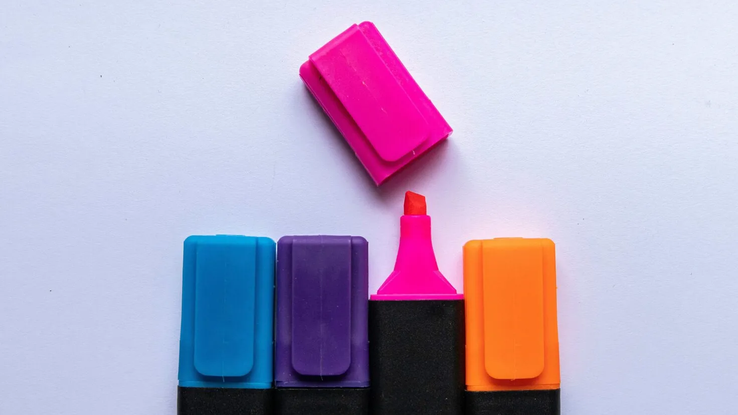 pink blue orange highlighters lined up