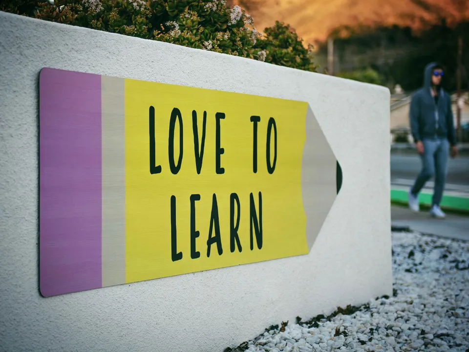 sign saying love to learn on a wall