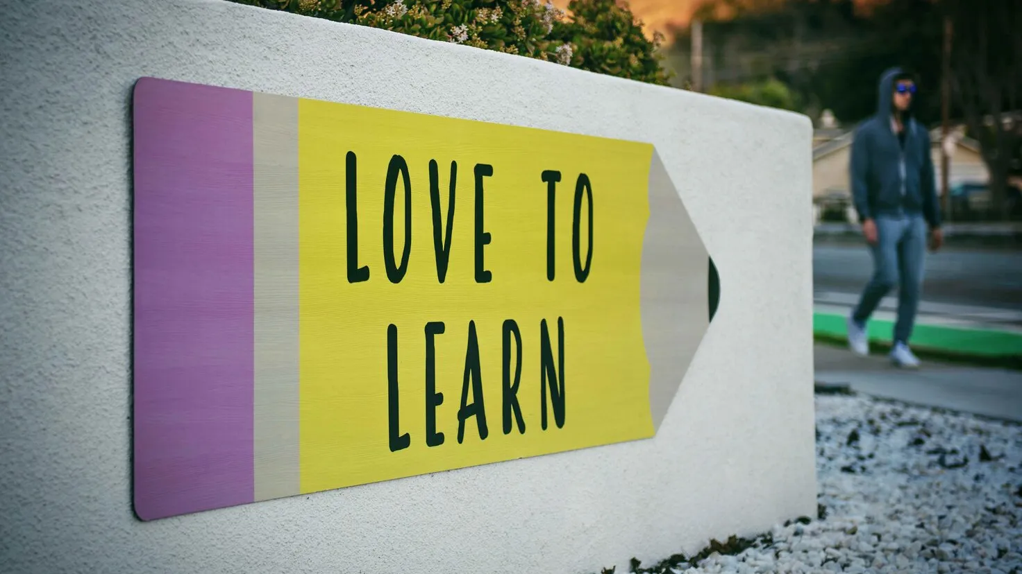 sign saying love to learn on a wall